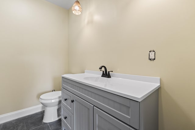 bathroom featuring tile patterned floors, vanity, and toilet