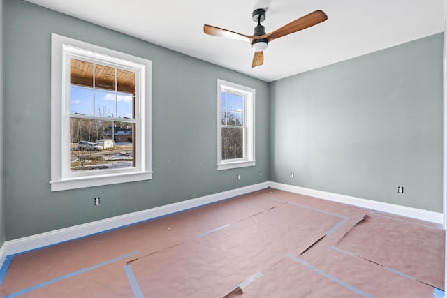 empty room featuring ceiling fan and a healthy amount of sunlight