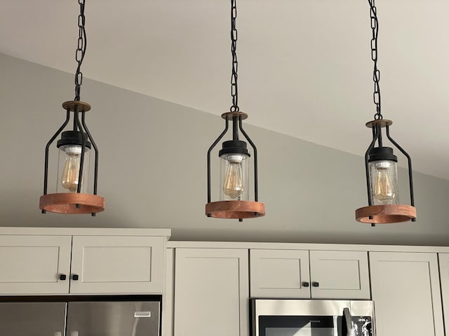 interior details with decorative light fixtures and white cabinetry