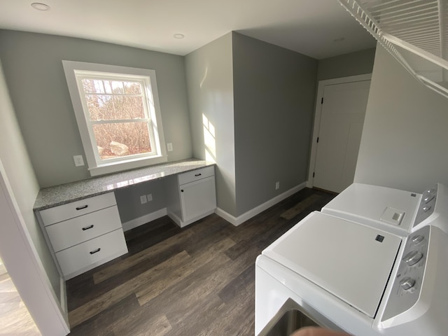 clothes washing area with washer and dryer and dark hardwood / wood-style flooring