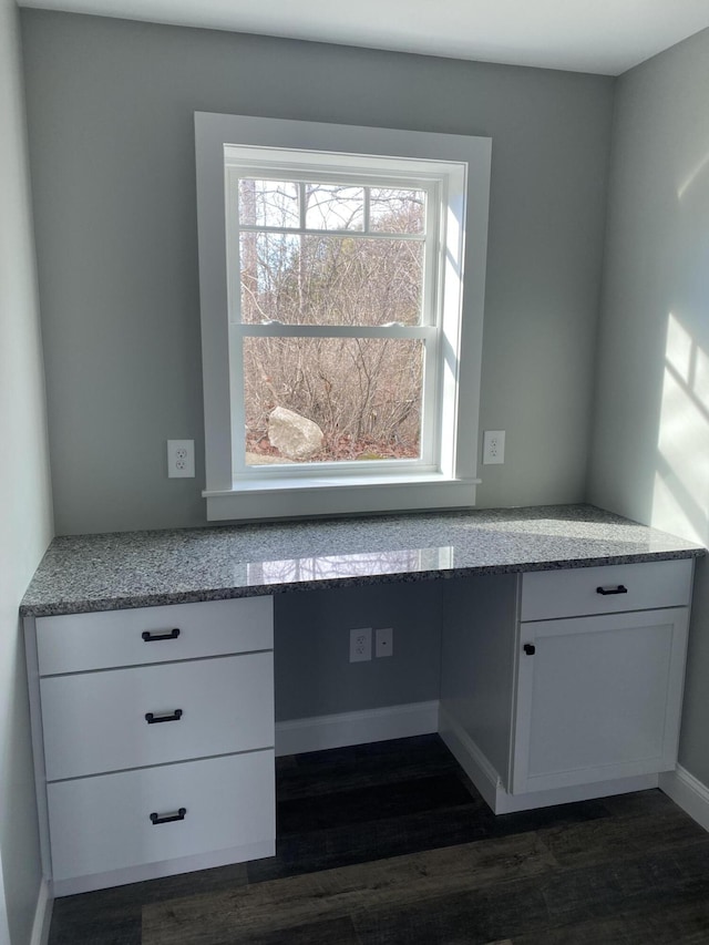 interior space with hardwood / wood-style floors and built in desk