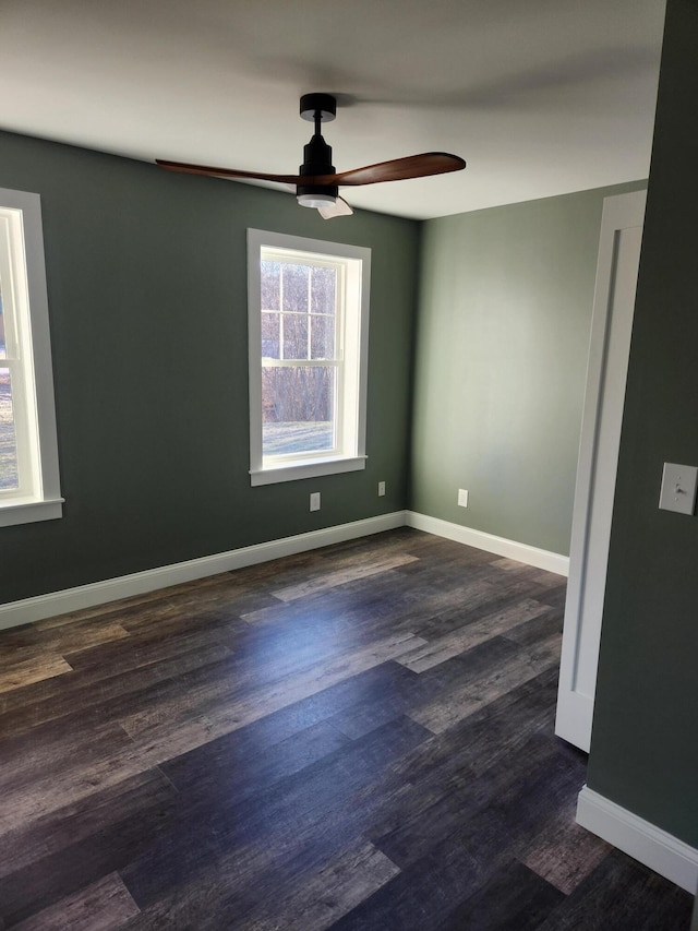 unfurnished room featuring ceiling fan and dark wood-type flooring