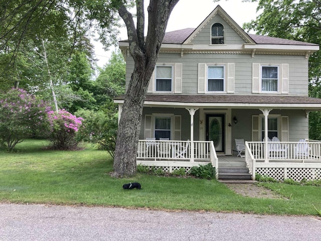 view of front of house with a front yard and covered porch