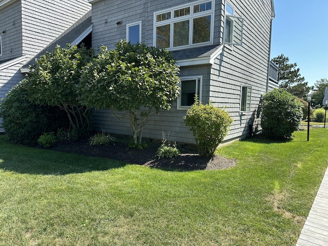 view of side of home featuring a lawn