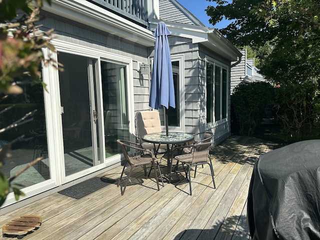 wooden terrace with a grill