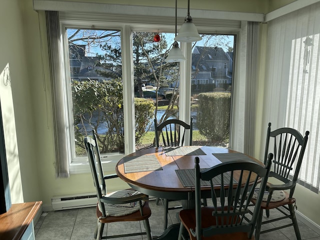 tiled dining space with a healthy amount of sunlight and a baseboard radiator