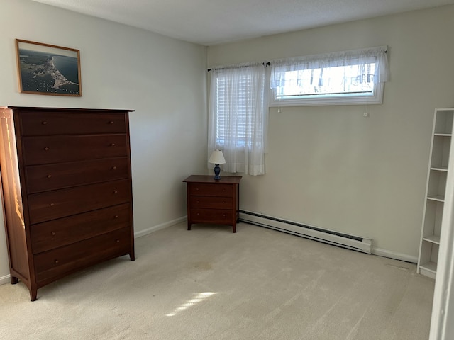 unfurnished bedroom with a baseboard radiator and light colored carpet