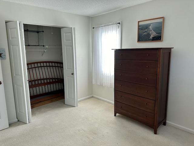 carpeted bedroom with a textured ceiling