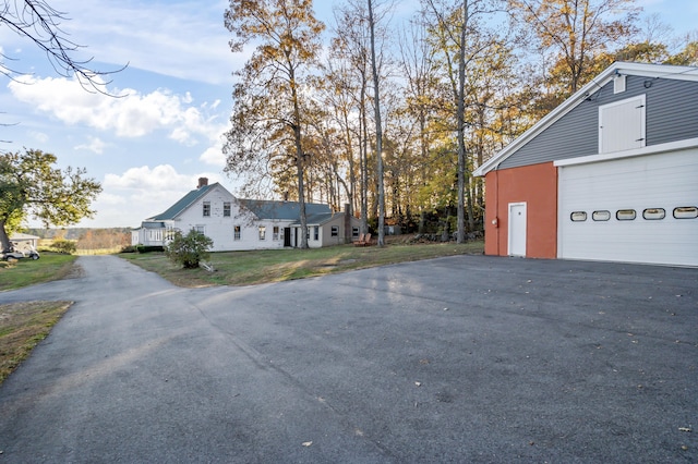 view of property exterior featuring a lawn and a garage