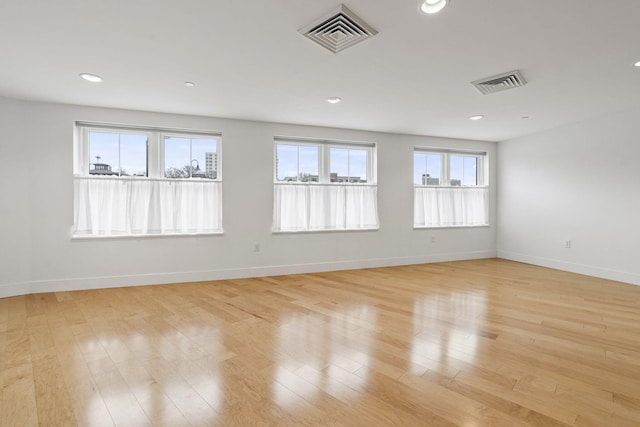 spare room featuring light hardwood / wood-style floors