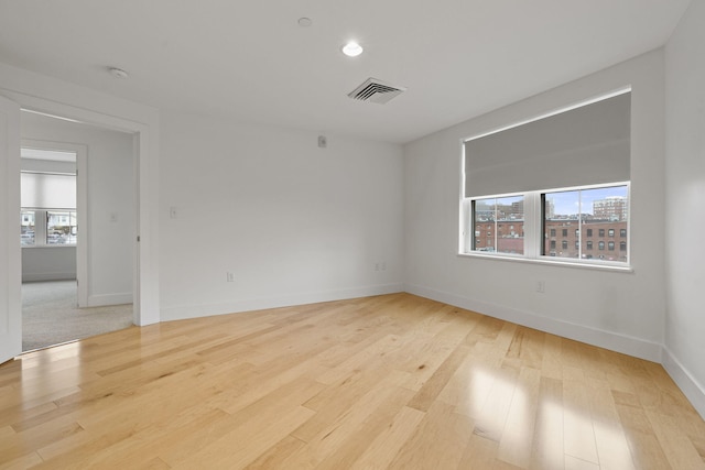 spare room with light hardwood / wood-style flooring