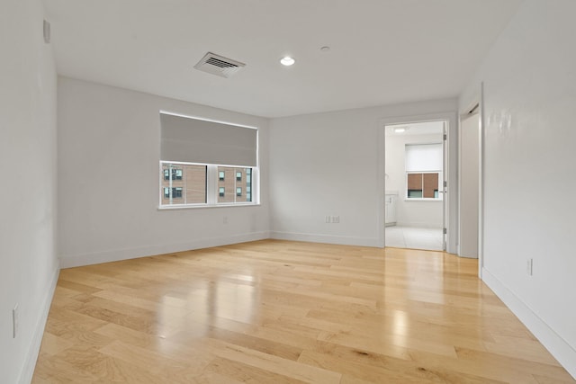 spare room with light hardwood / wood-style floors