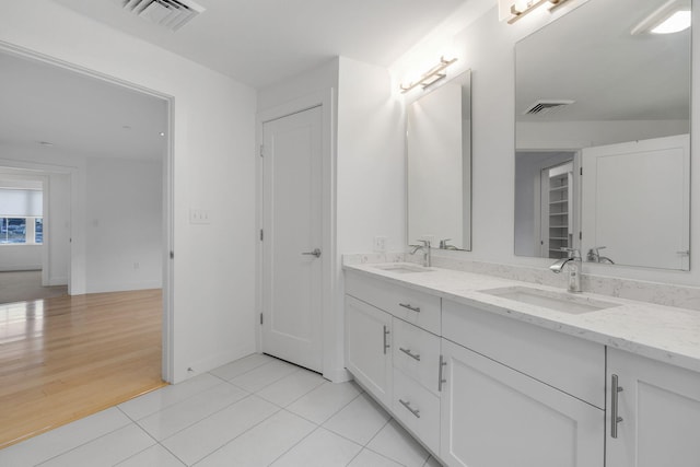 bathroom with vanity and wood-type flooring