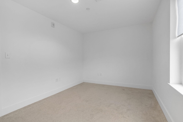 unfurnished room with light colored carpet