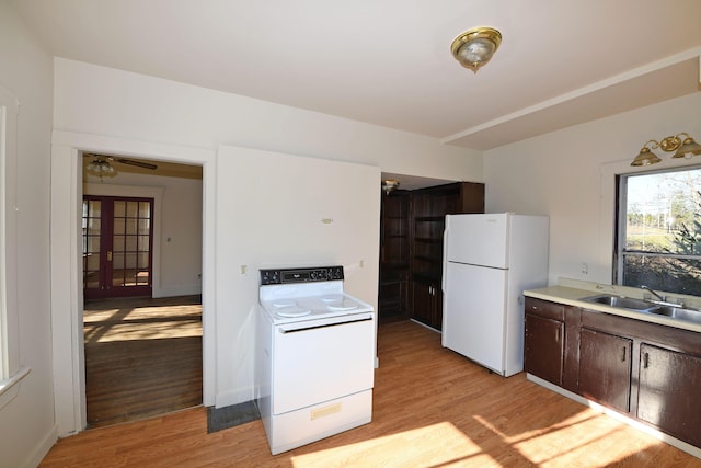 kitchen with white appliances, french doors, sink, dark brown cabinets, and light hardwood / wood-style floors