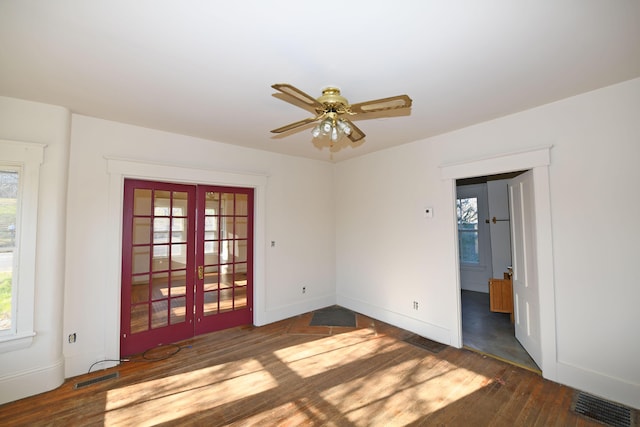 empty room with french doors, dark hardwood / wood-style flooring, and ceiling fan