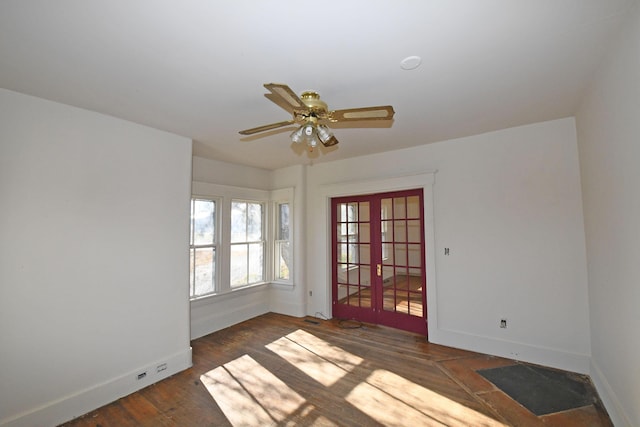 unfurnished room with ceiling fan, french doors, and dark wood-type flooring