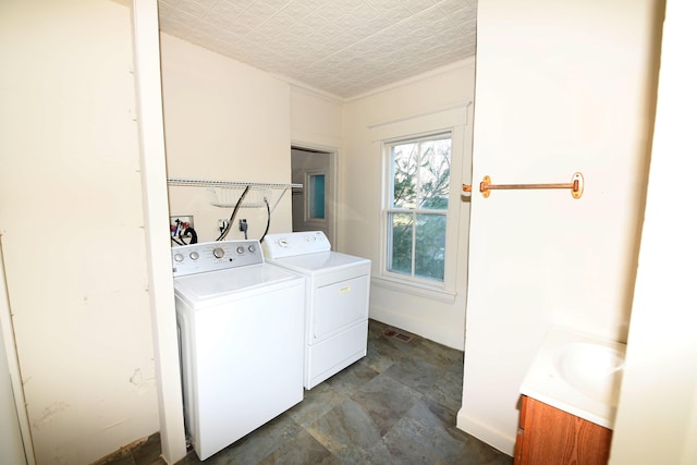 clothes washing area featuring separate washer and dryer