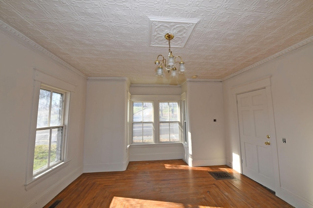 unfurnished room featuring a wealth of natural light and a notable chandelier