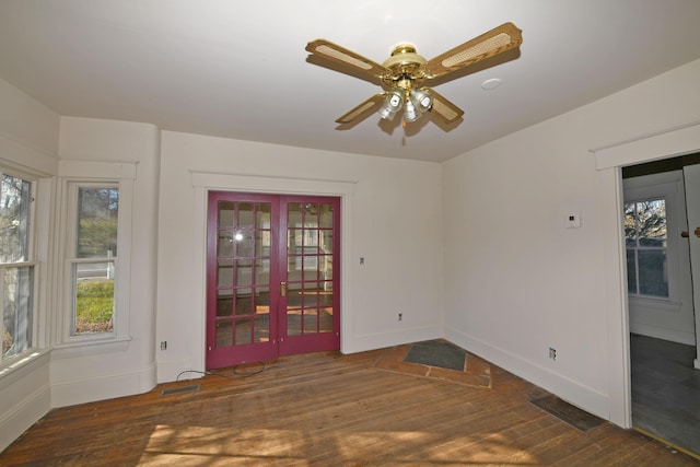 empty room featuring ceiling fan and dark hardwood / wood-style flooring