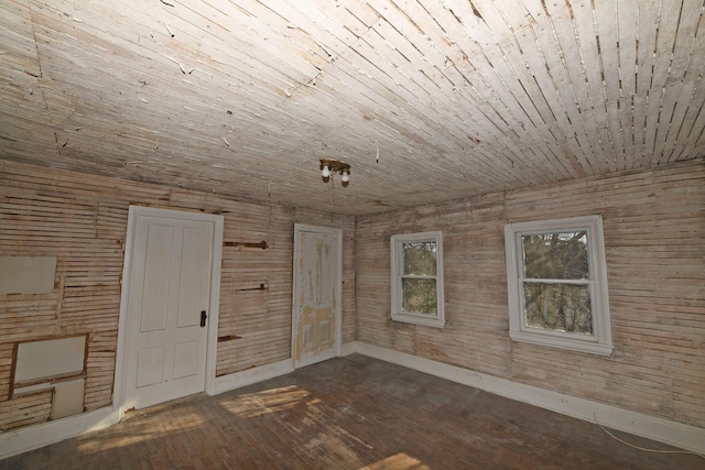 unfurnished room with dark hardwood / wood-style flooring