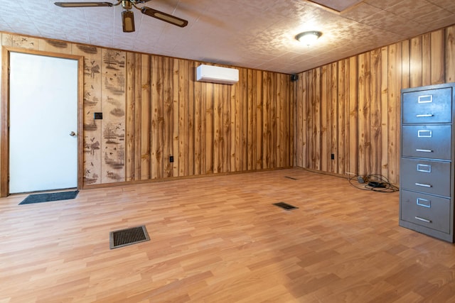 basement with wood-type flooring, a wall unit AC, and wooden walls