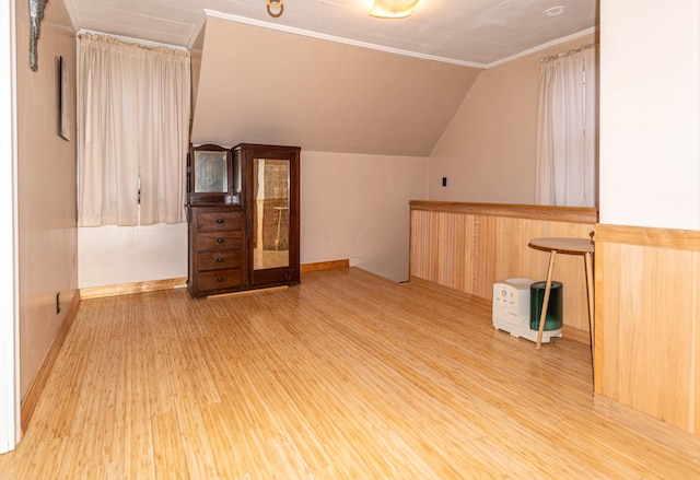 additional living space featuring light hardwood / wood-style floors and lofted ceiling