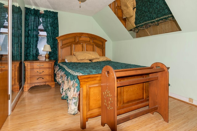 bedroom featuring light wood-type flooring and a textured ceiling