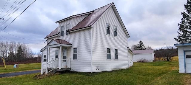 view of side of home with a yard