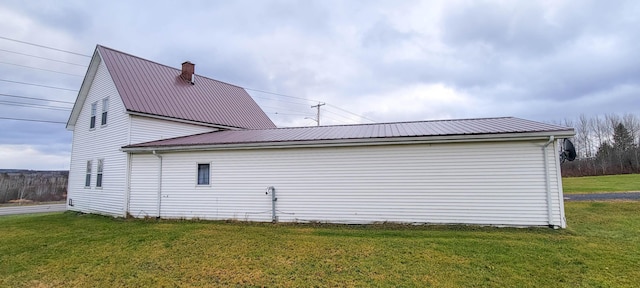 view of side of home featuring a lawn