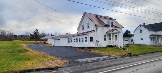 view of front of property featuring a garage and a front lawn