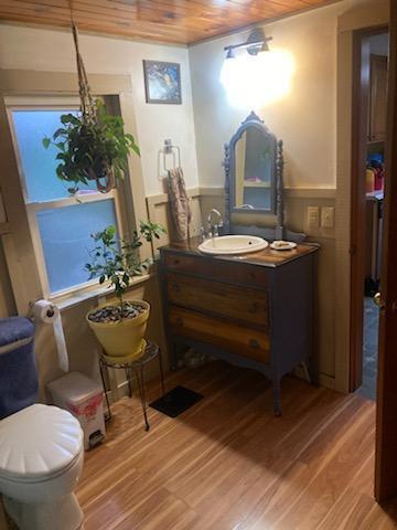 bathroom featuring hardwood / wood-style floors, vanity, and wooden ceiling