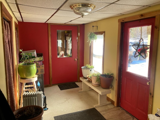 doorway to outside with a paneled ceiling