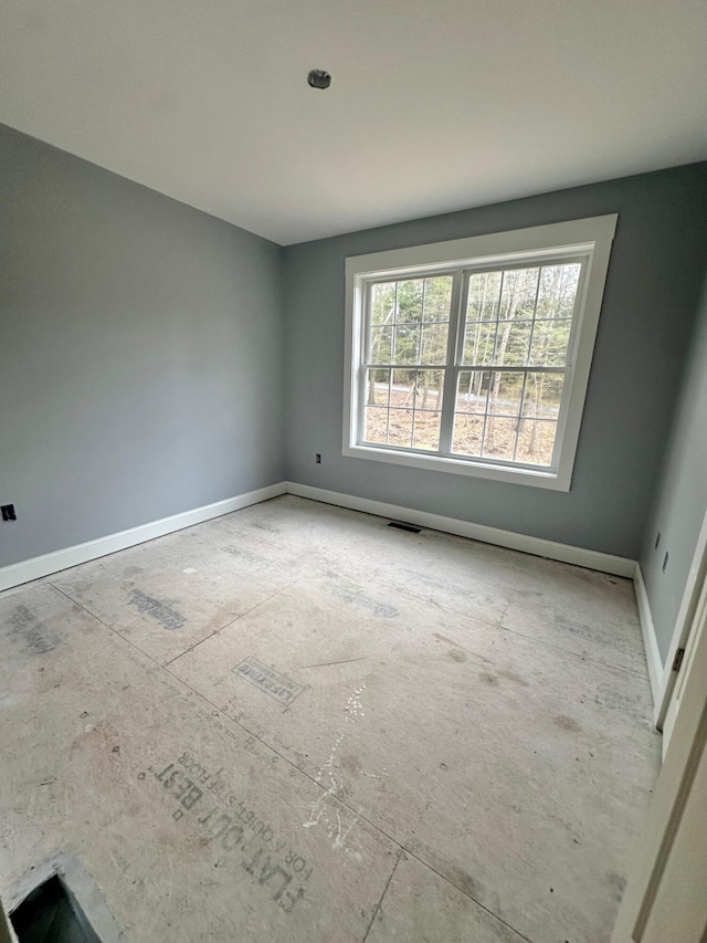 spare room with baseboards