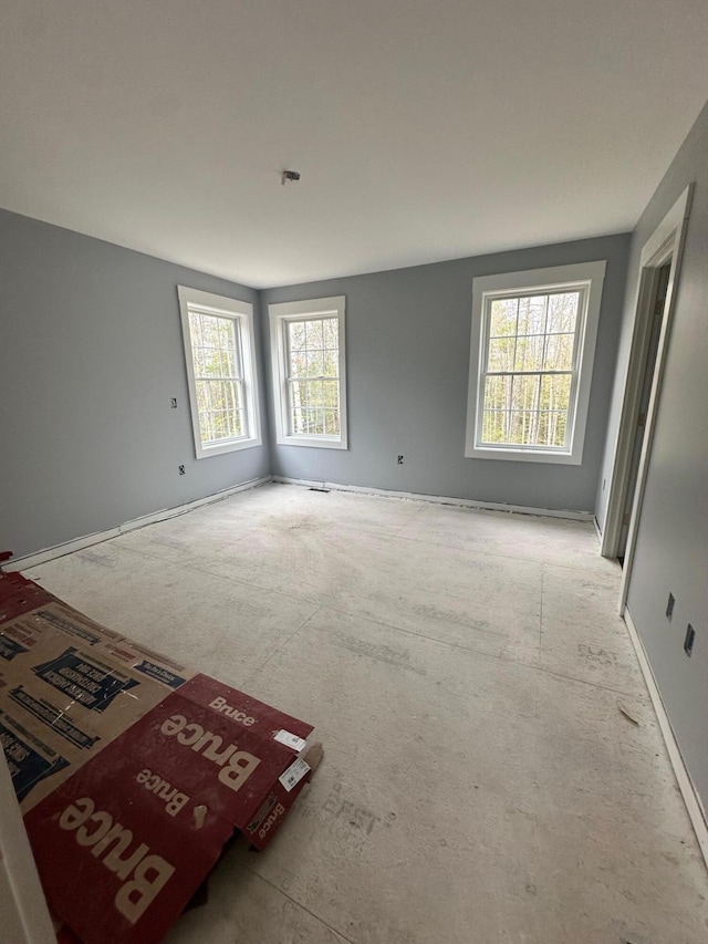 carpeted spare room with baseboards