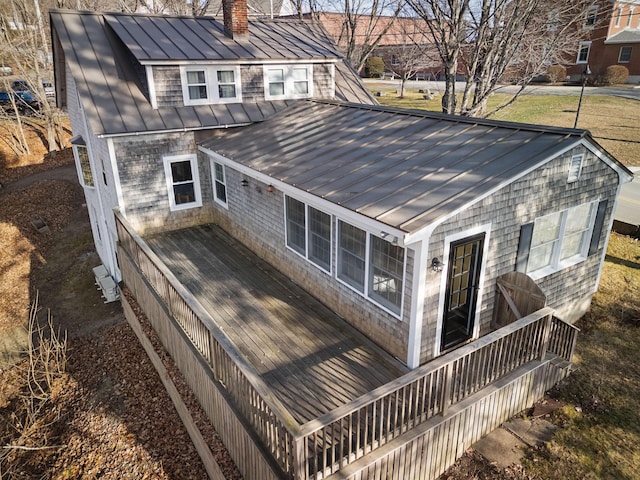 rear view of property featuring a wooden deck