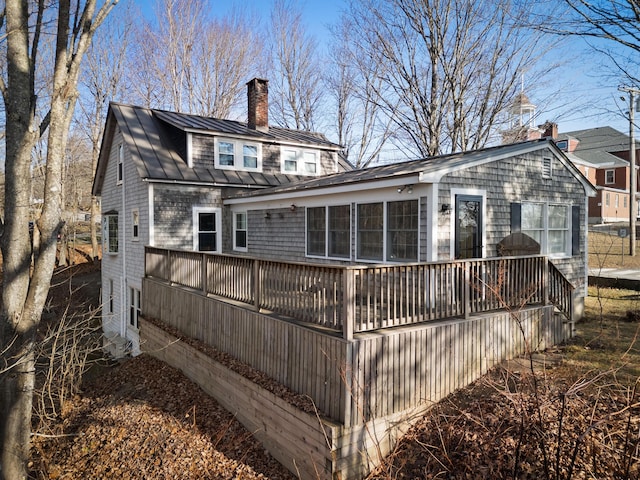 back of house featuring a sunroom and a deck