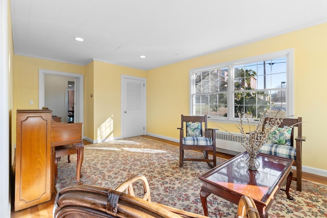 living room featuring hardwood / wood-style flooring and ornamental molding