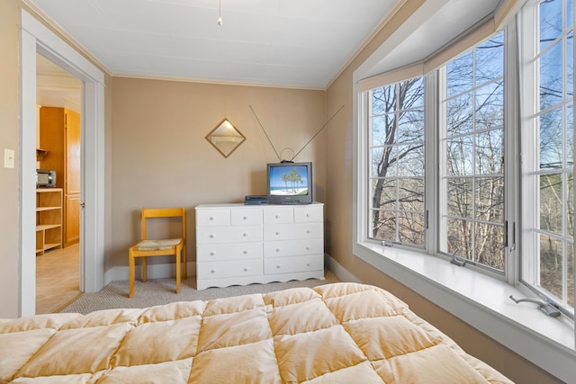 carpeted bedroom featuring multiple windows and ornamental molding