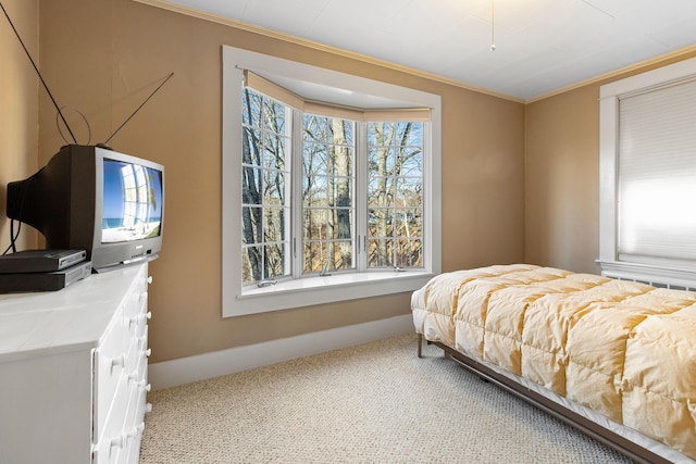 carpeted bedroom featuring crown molding