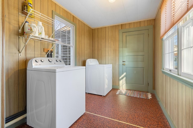 washroom featuring separate washer and dryer and wooden walls