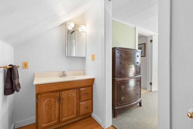 bathroom featuring vanity and vaulted ceiling