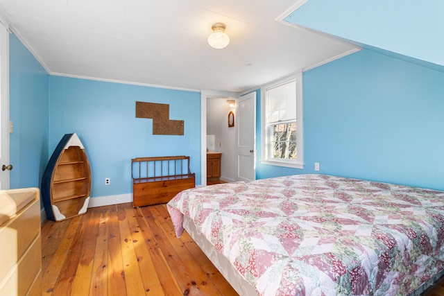 bedroom featuring hardwood / wood-style floors and ornamental molding