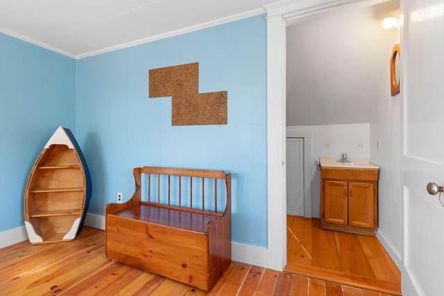 sitting room featuring sink, light hardwood / wood-style floors, and ornamental molding