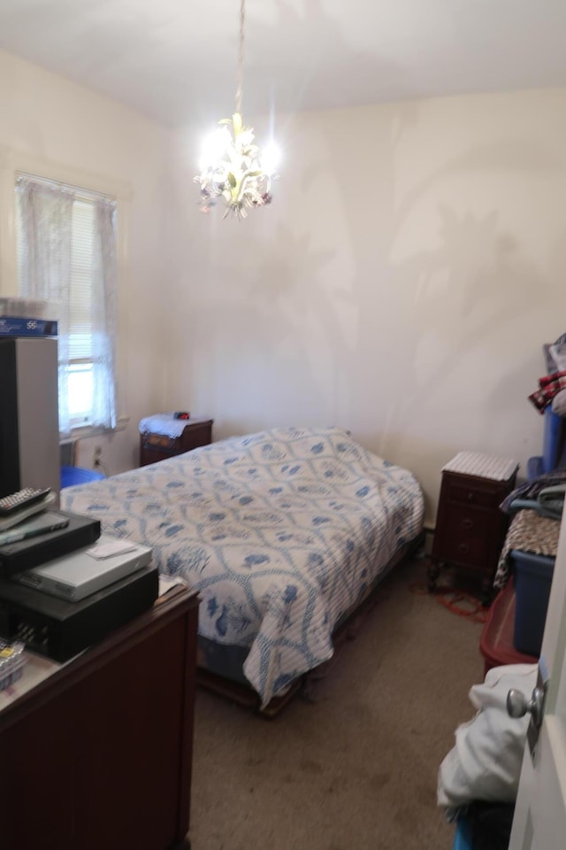 bedroom with carpet floors and an inviting chandelier