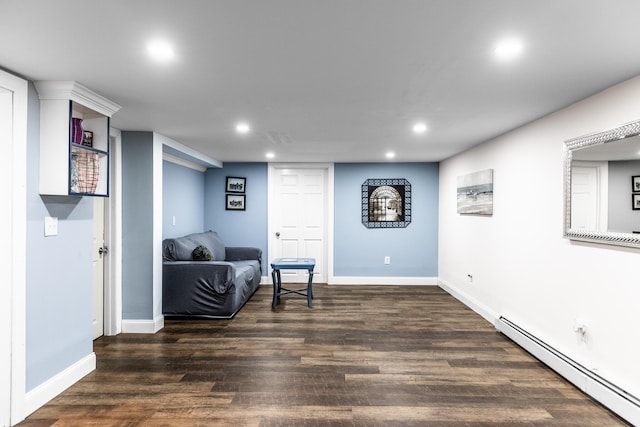 sitting room featuring dark wood-type flooring and a baseboard heating unit