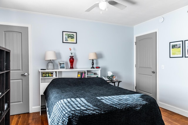 bedroom with ornamental molding, ceiling fan, and dark wood-type flooring