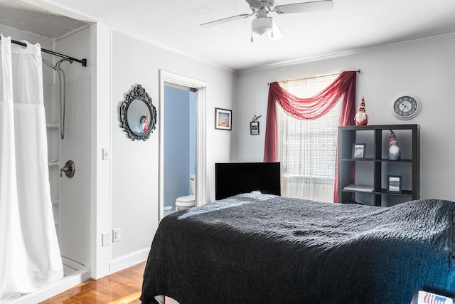 bedroom with connected bathroom, ceiling fan, ornamental molding, and hardwood / wood-style flooring