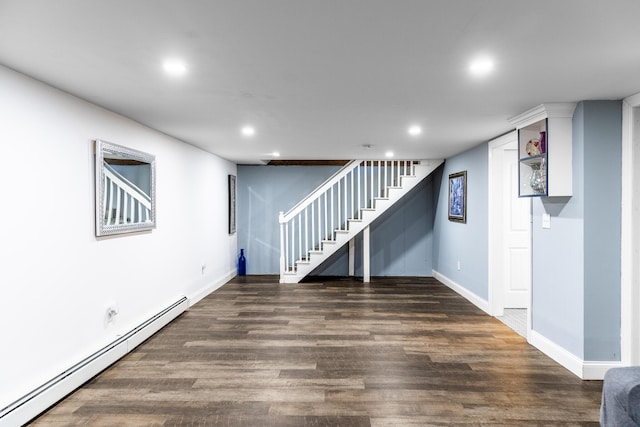 basement with dark hardwood / wood-style flooring and a baseboard radiator