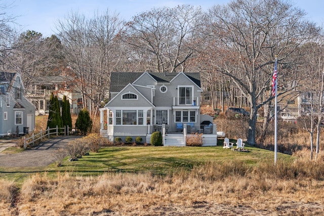 view of front of property with a front yard and a sunroom